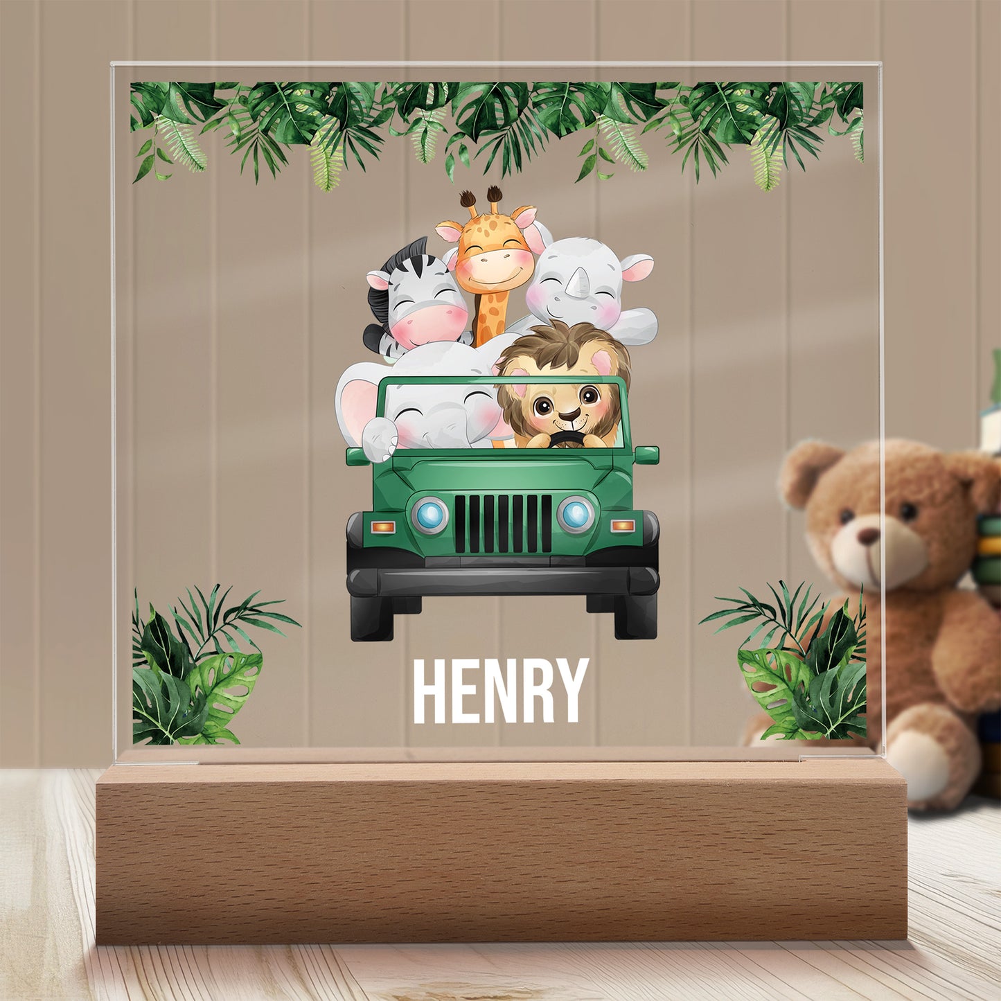 Safari Friends Personalized Night Light with Battery powered base featured on a light timber table with a neutral beige panelled wall and child's teddy bear in the background.