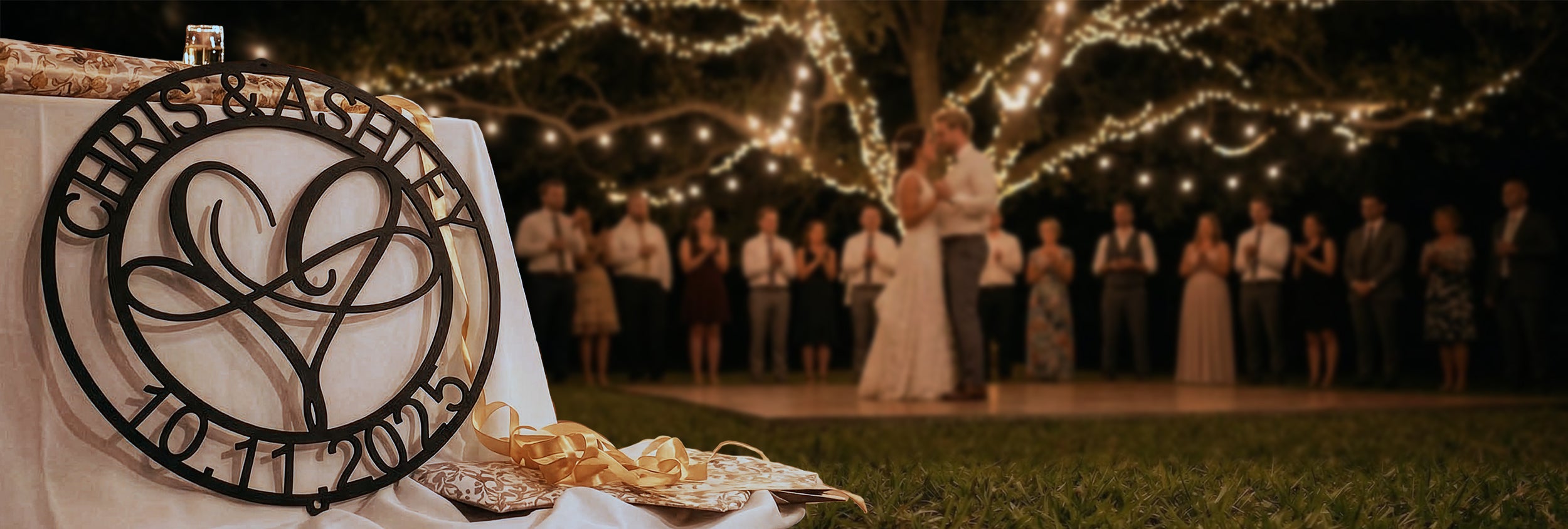 Wedding ceremony with guests and a decorative sign in the foreground.