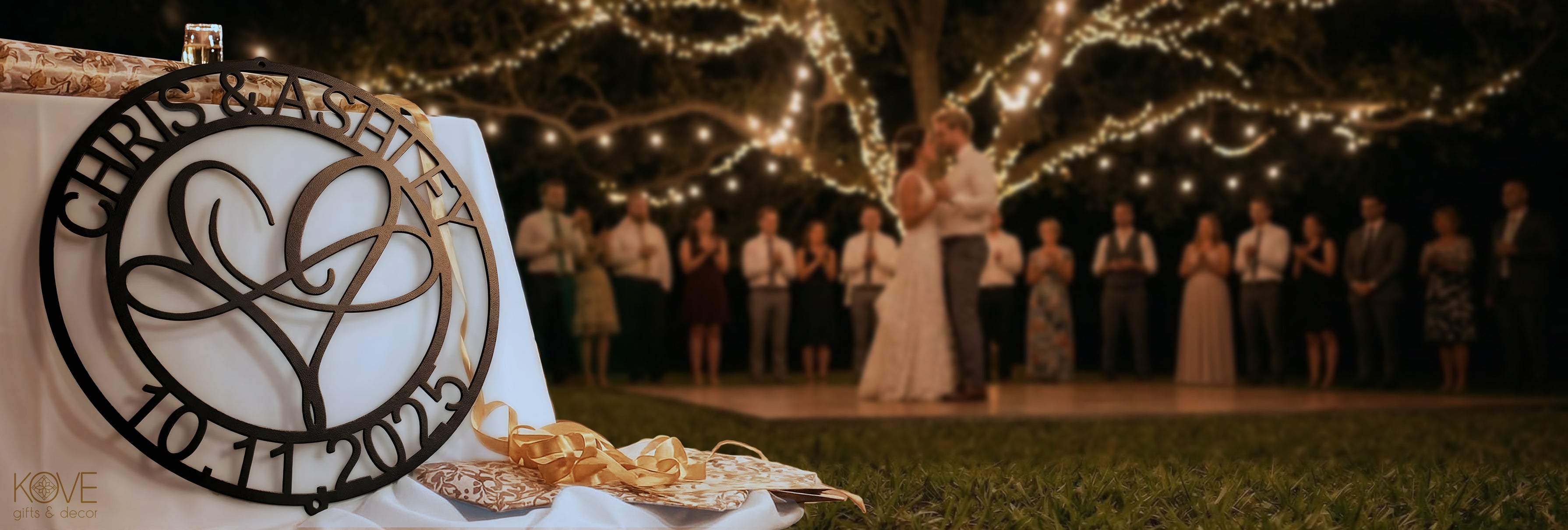 Infinite Love Personalized Metal Decor piece featured in the foreground with a romantic night wedding dance scene blurred in the background.
