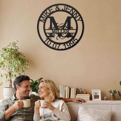 Couple sitting on a couch enjoying coffee with a Black Fanciful Monogram Personalized Metal Decor piece on the wall above them.