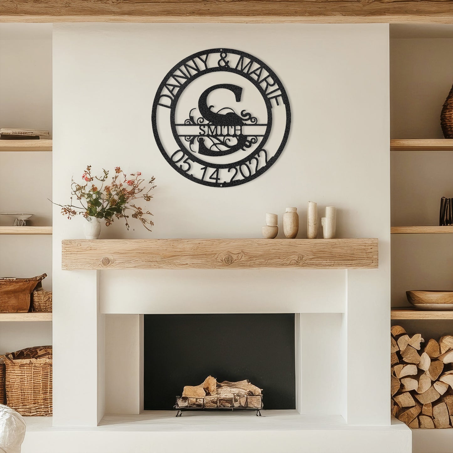 Black Fanciful Monogram Personalized Metal Decor mounted above a modern fireplace.