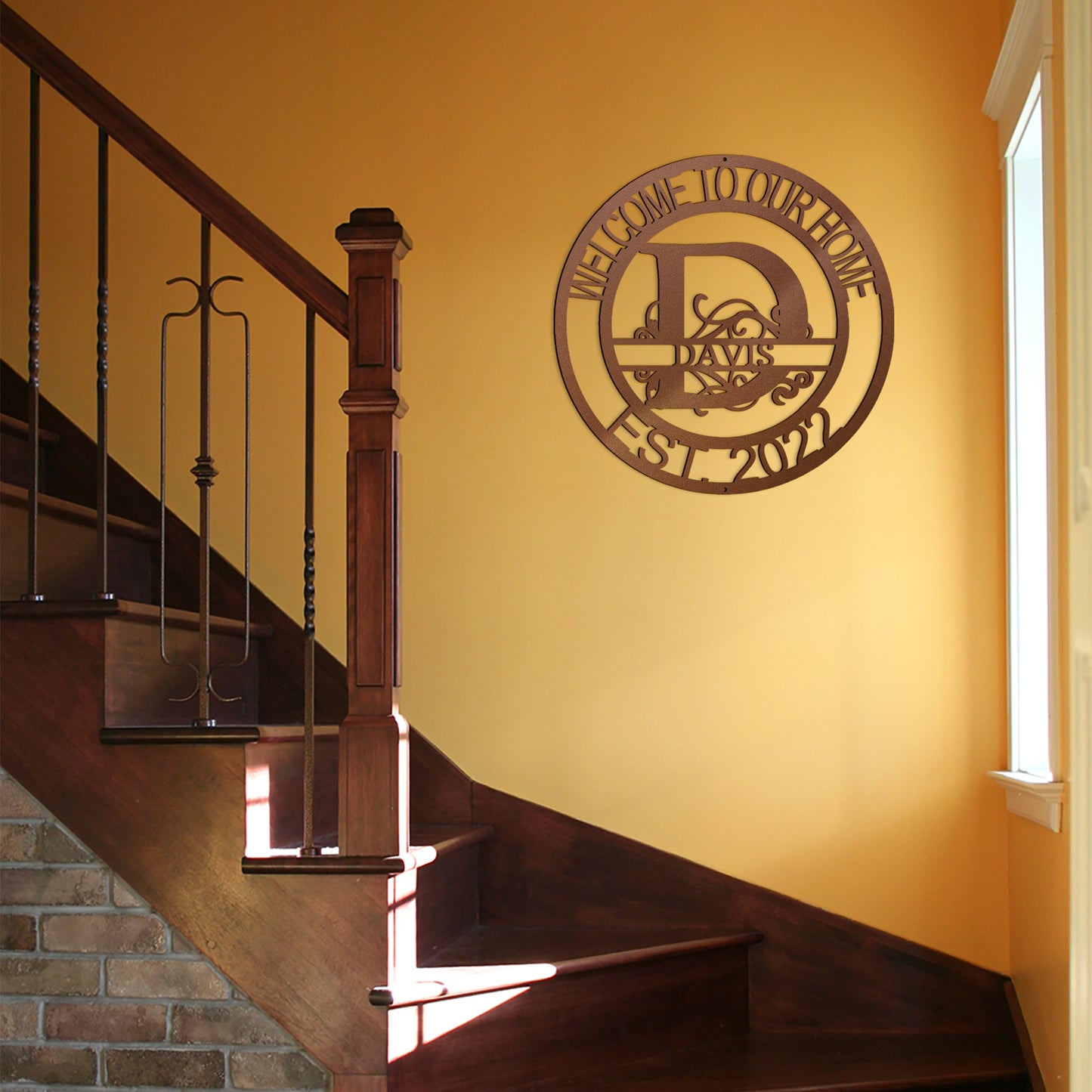 Copper Fanciful Monogram Personalized Metal Decor featured on a bright yellow wall over a staircase in a traditional home.