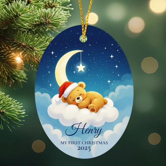 Decorative personlized ornament with a teddy bear wearing a Santa hat, surrounded by stars and a moon, on a cloud.