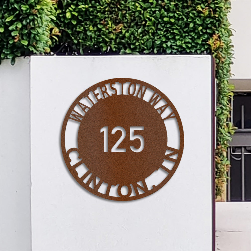 Close-up of Copper Bold Circle Street Address Metal Sign fitted to modern front entrance wall.