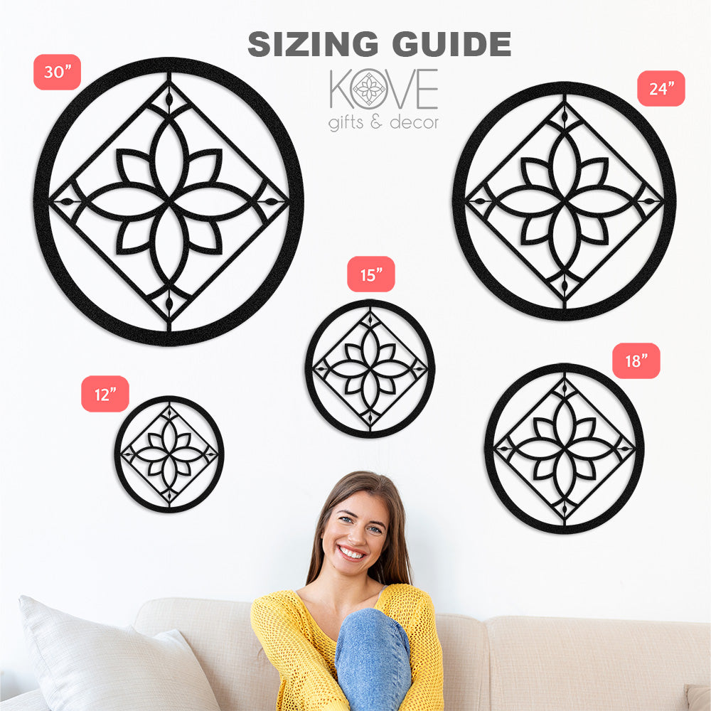 A women sits on a couch with sample metal decor pieces on the wall behind her showing the various sizes available.