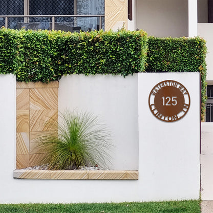 Copper Bold Circle Street Address Metal Sign fitted to modern front entrance wall